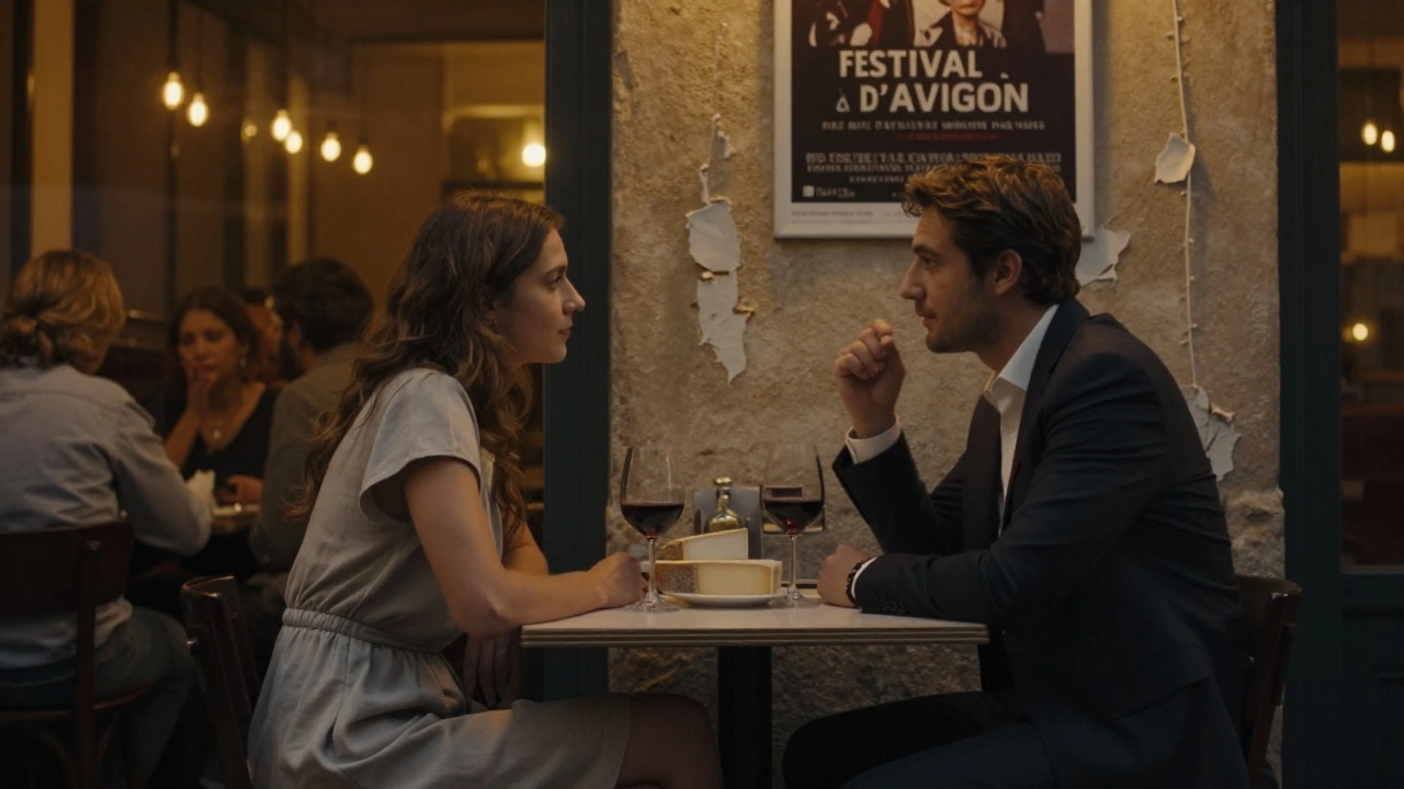 Two people having quiet conversation over wine and cheese in a cozy Avignon café at dusk.